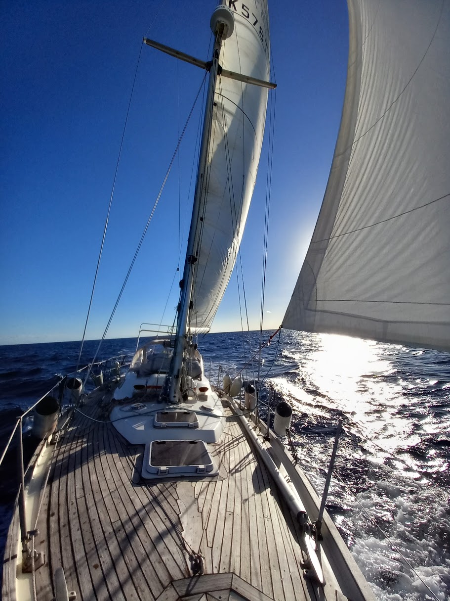 The Biscay 36 at anchor at sunset, showing her full profile and long keel.